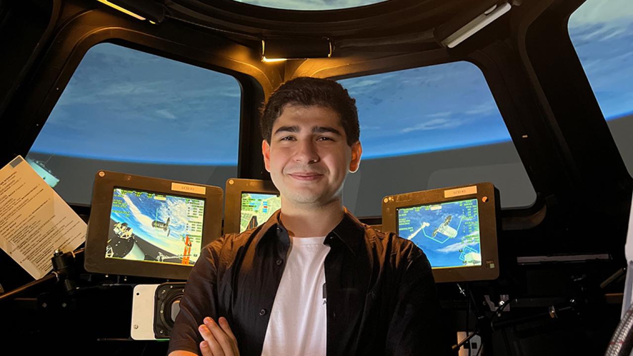 Aidan Guerra stands in the Alpha Dome