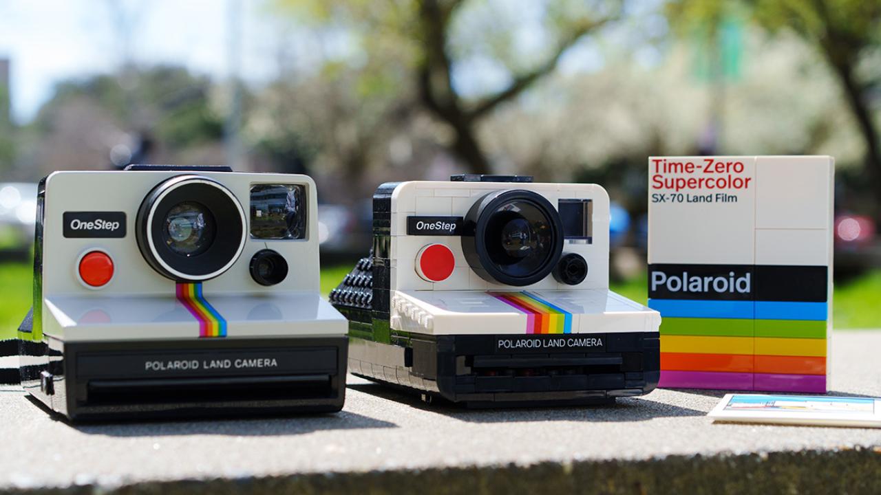 real polaroid camera sits next to a lego version