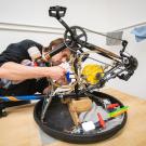 Student works on a machine made from bicycle parts