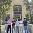 Five people stand outside of an engineering building on the UC Davis campus