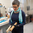 Woman holds rectangular materials in a lab